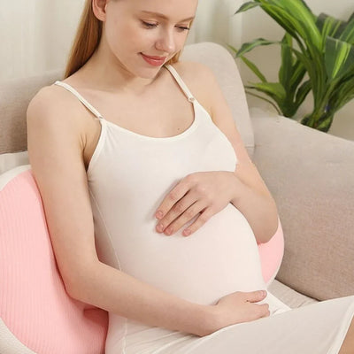 Pregnant woman using pink Adjustable Pregnancy Support Pillow for comfortable back and belly support