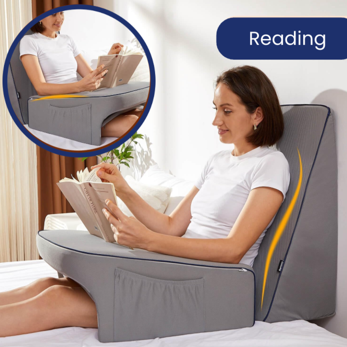 Woman reading comfortably using gray Dock Support Cushion with backrest and arm support by getblissyneck
