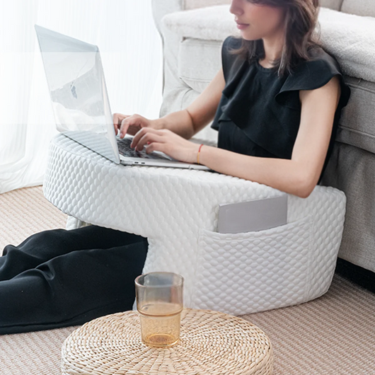 White quilted Lap Reading Pillow supporting a laptop for comfortable work on the floor