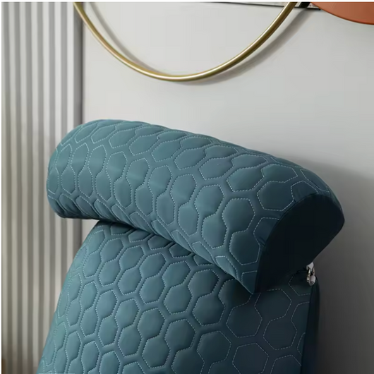 Blue textured getblissyneck Reading Pillow with hexagonal stitching on a chair headrest