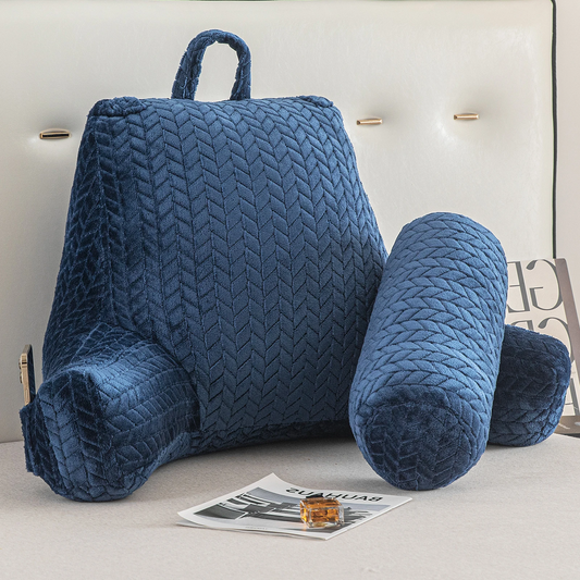 Blue Reading Wedge Pillow with armrests and a handle on top placed on a bed with a magazine